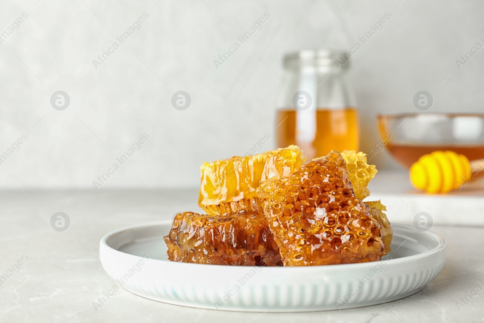 Photo of Plate with fresh sweet honeycombs on table