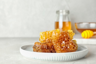 Photo of Plate with fresh sweet honeycombs on table