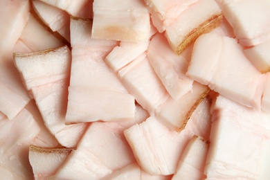 Slices of pork fatback as background, closeup