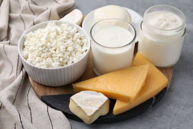 Photo of Different fresh dairy products on grey table