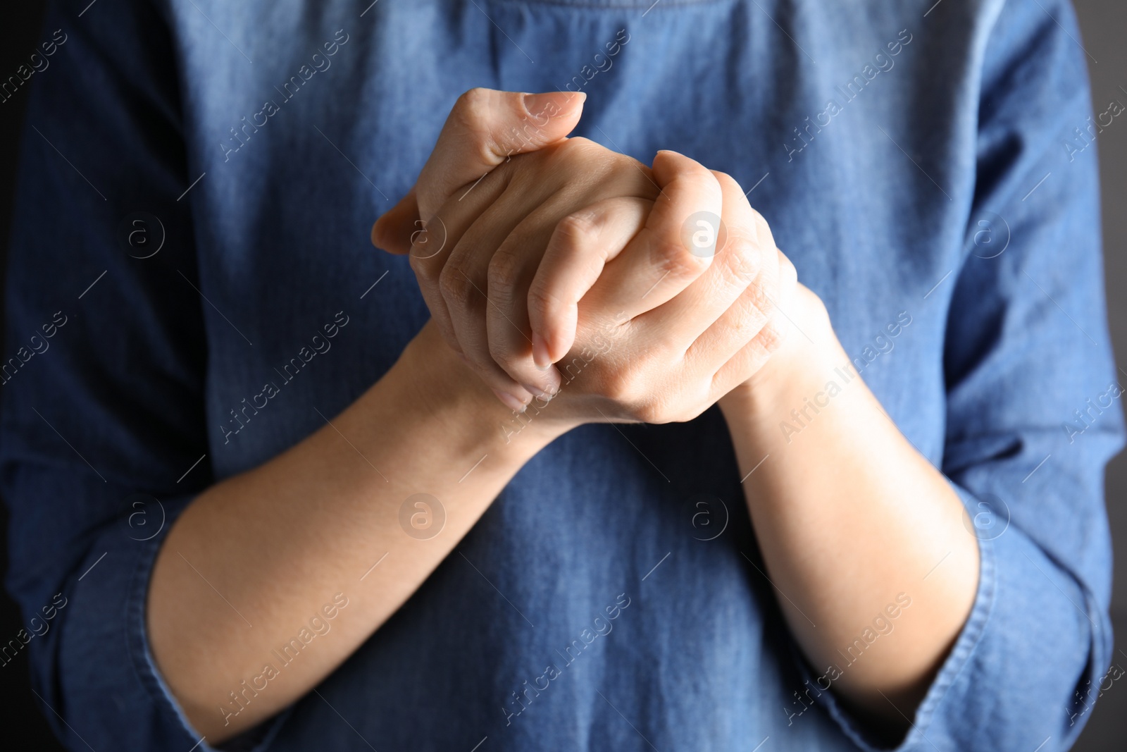 Photo of Woman showing word believe, closeup. Sign language