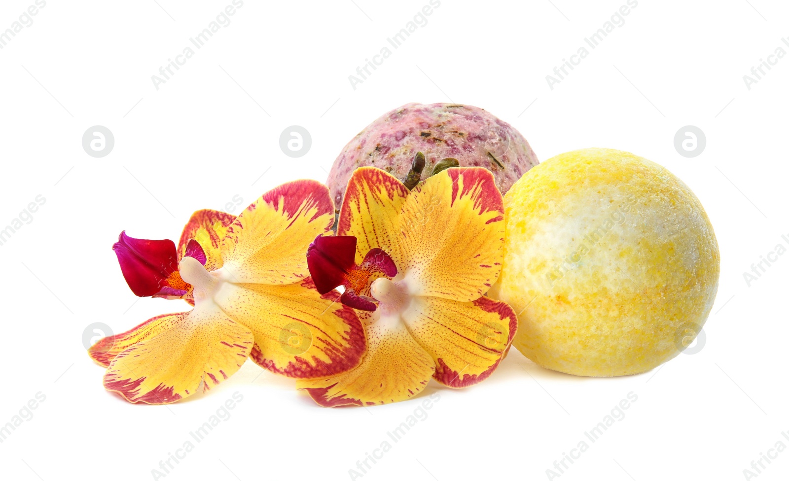 Photo of Bath bombs and flowers on white background