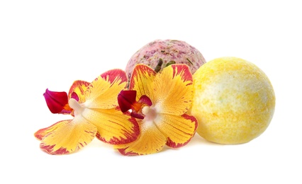 Photo of Bath bombs and flowers on white background