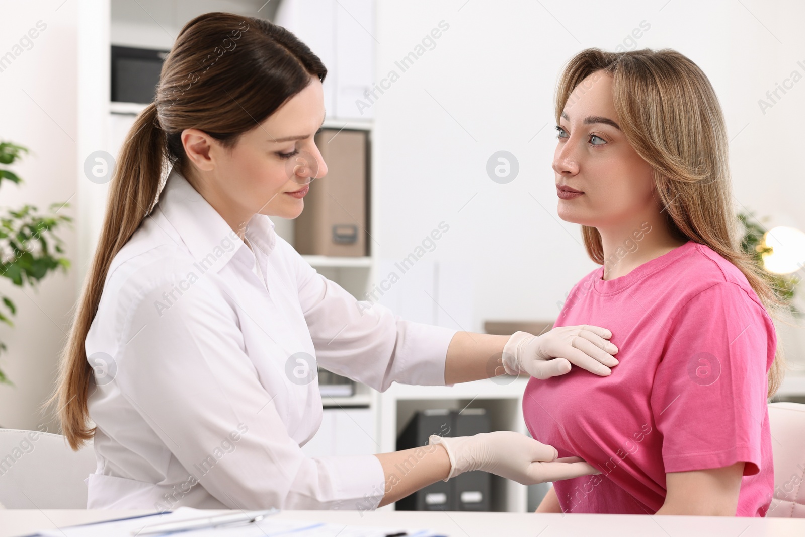 Photo of Mammologist checking young woman's breast in hospital