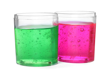 Photo of Colorful slimes in plastic containers isolated on white. Antistress toy