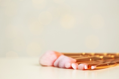 Photo of Set of makeup brushes on table. Space for text