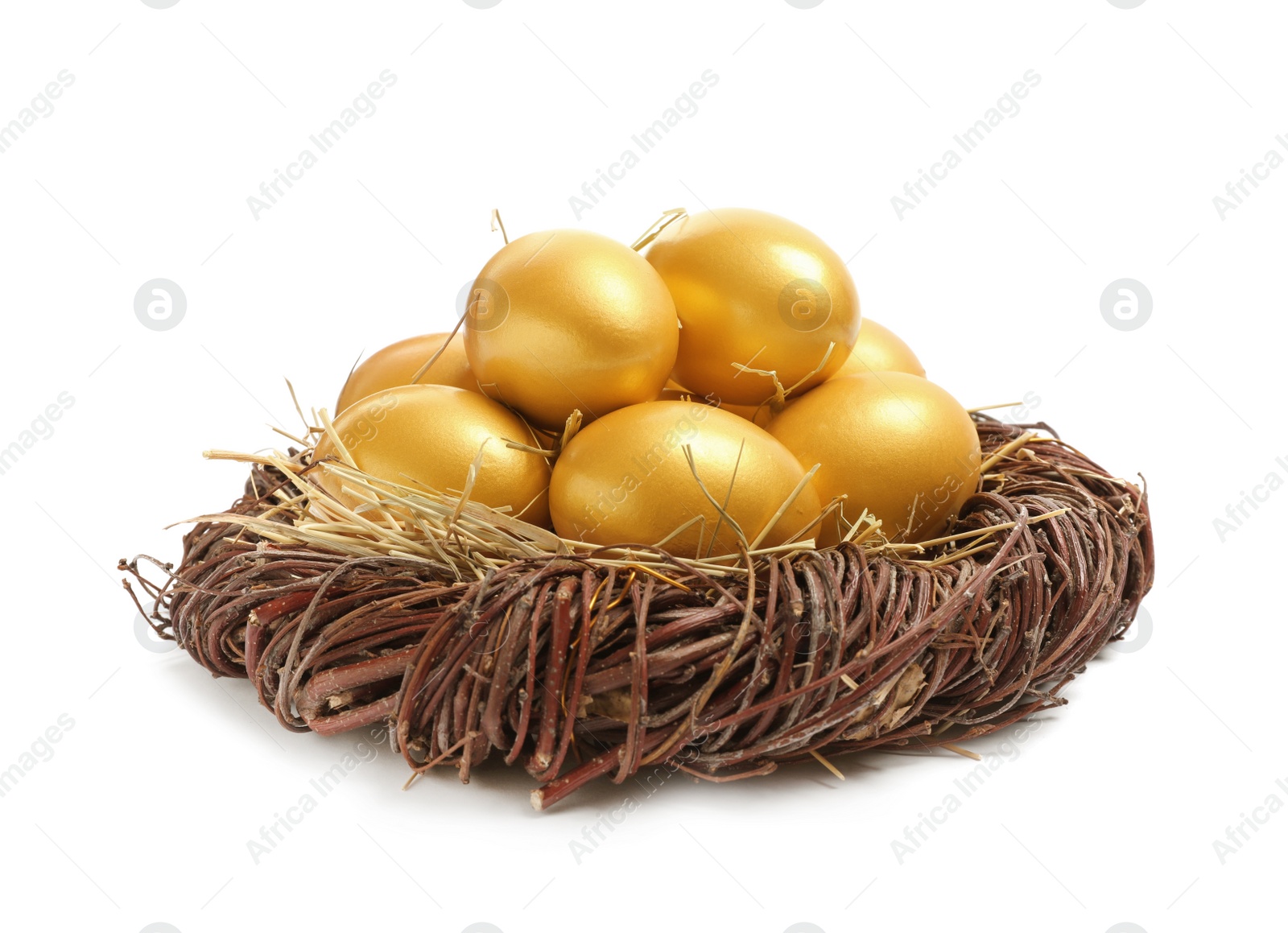 Photo of Shiny golden eggs in nest on white background