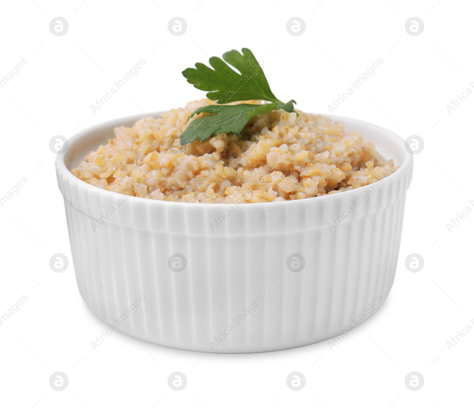 Photo of Tasty wheat porridge with parsley in bowl isolated on white