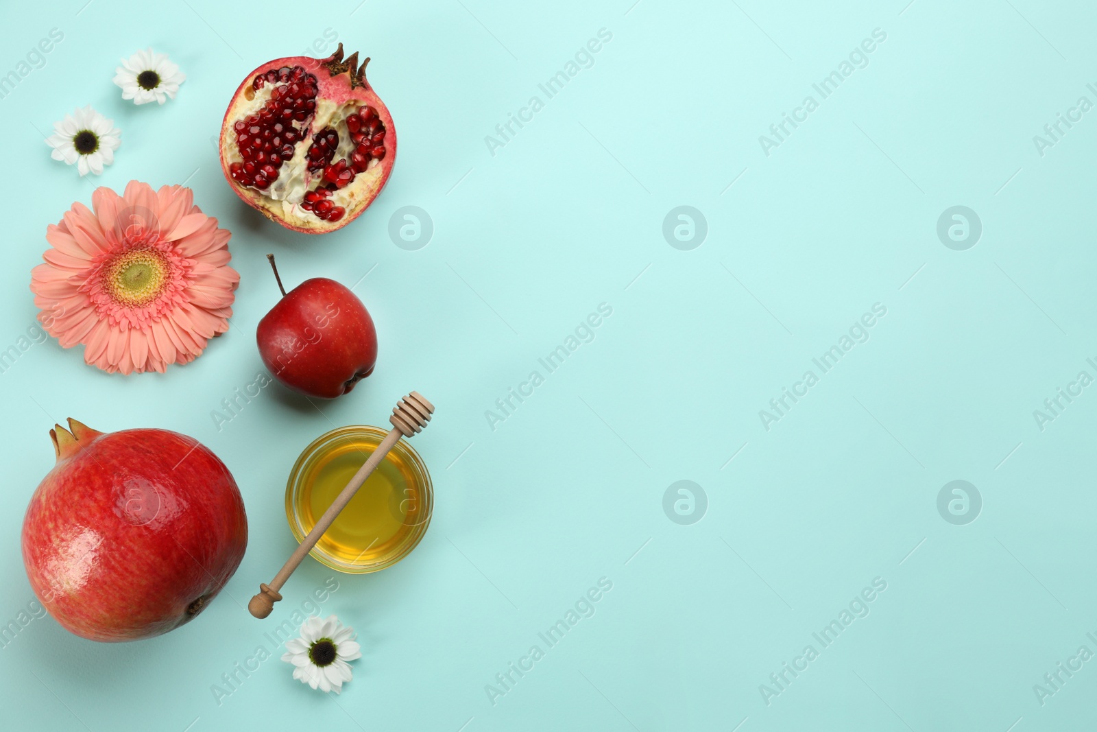 Photo of Flat lay composition with Rosh Hashanah holiday attributes on light blue background. Space for text