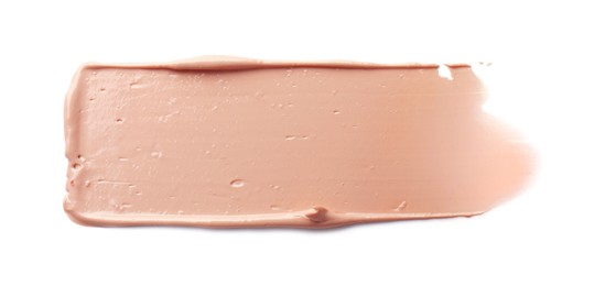 Photo of Stroke of pink correcting concealer isolated on white, top view