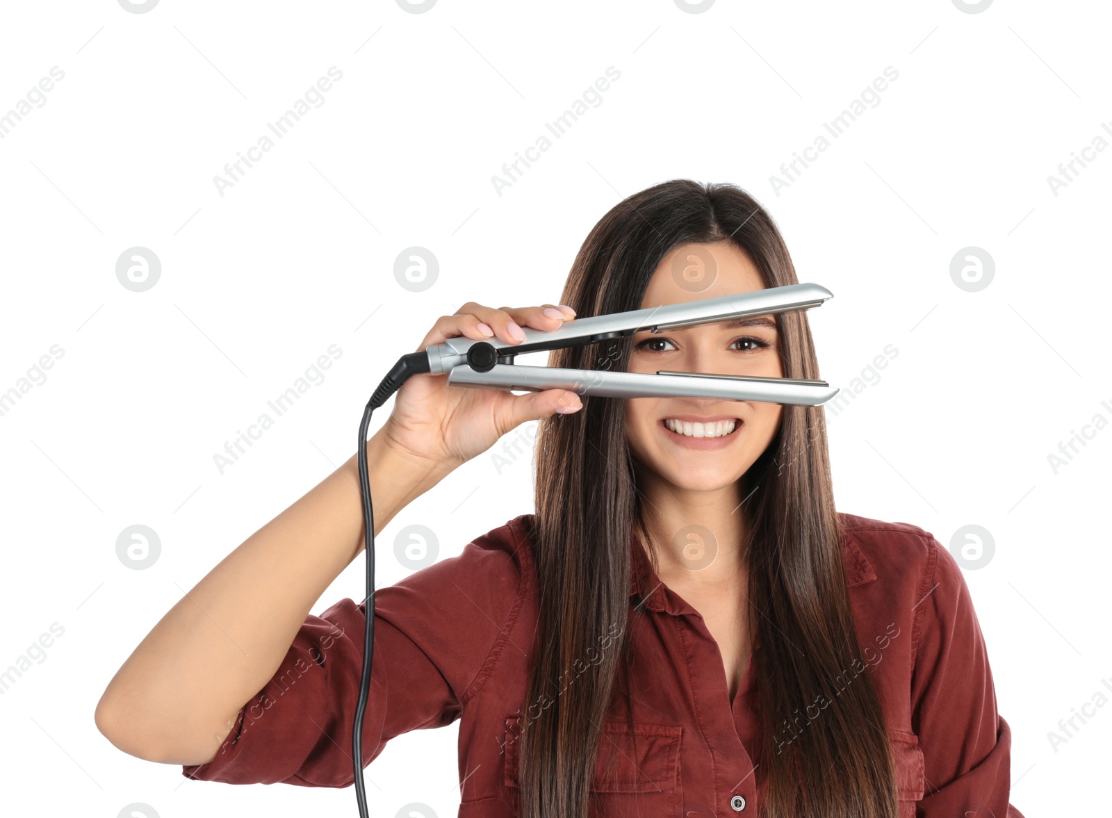 Photo of Young woman with modern hair iron on white background