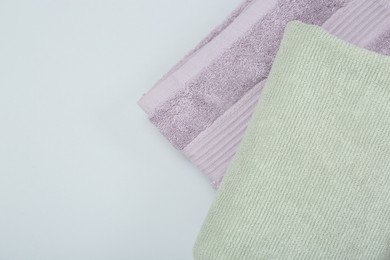 Photo of Different soft towels on light grey background, top view. Space for text
