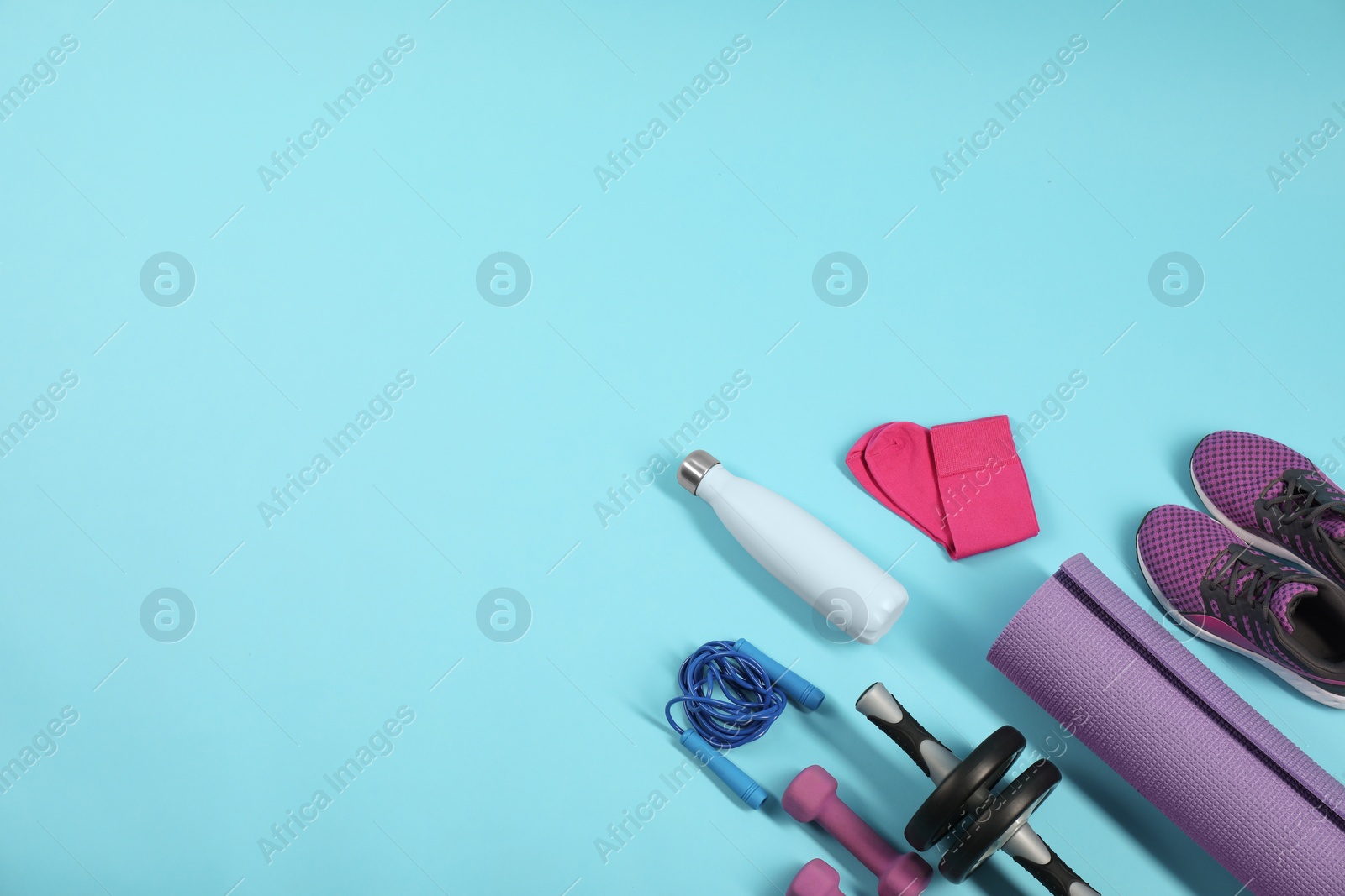 Photo of Different sports equipment on light blue background, flat lay. Space for text