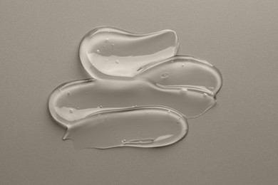 Photo of Sample of clear cosmetic gel on grey background, top view