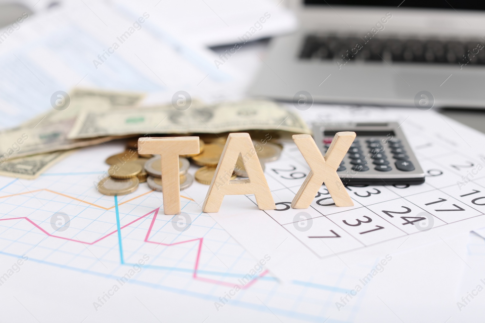 Photo of Word TAX, money and calculator on table