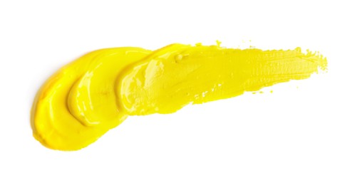 Photo of Yellow paint strokes drawn with brush on white background, top view