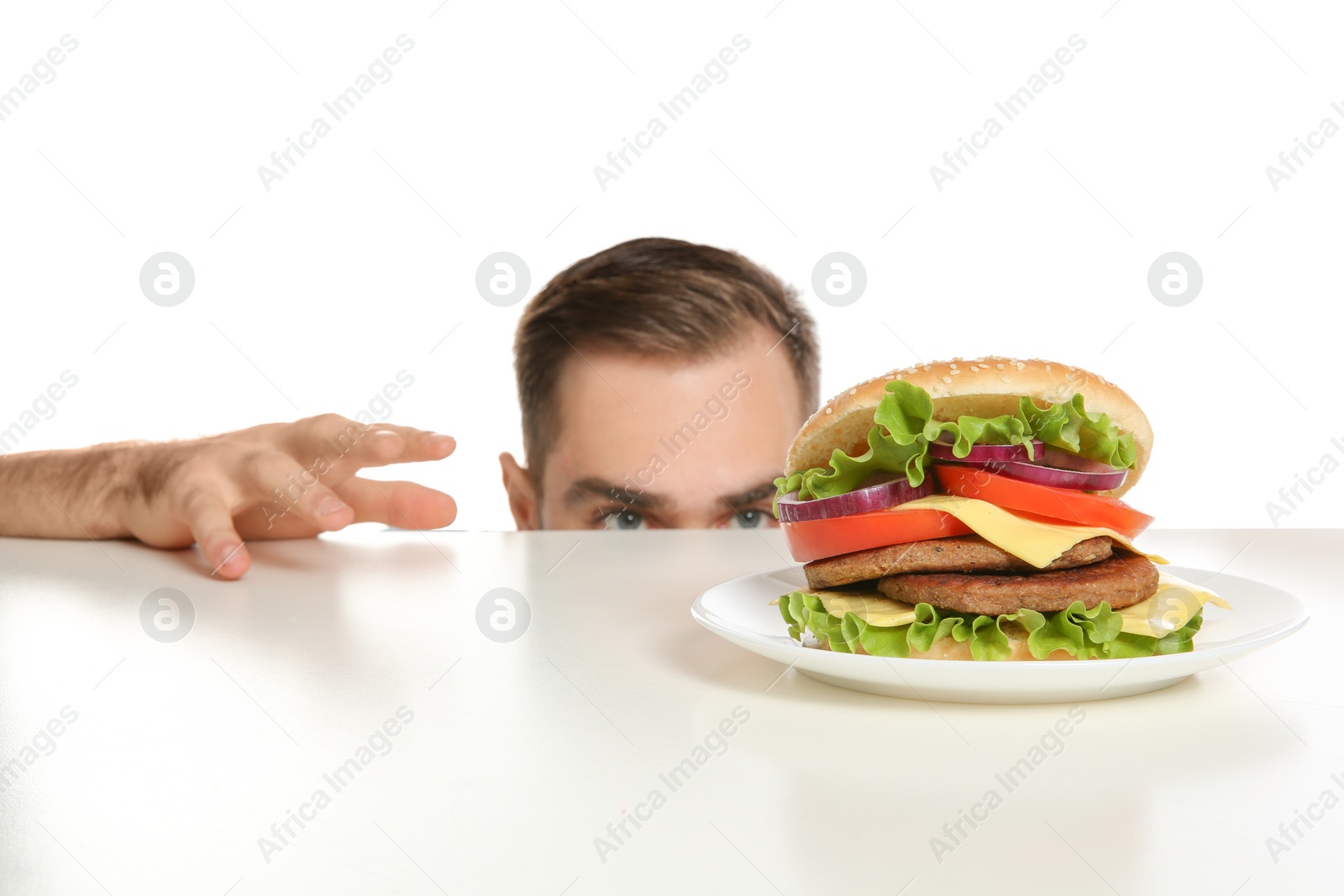 Photo of Young man with tasty burger on white background