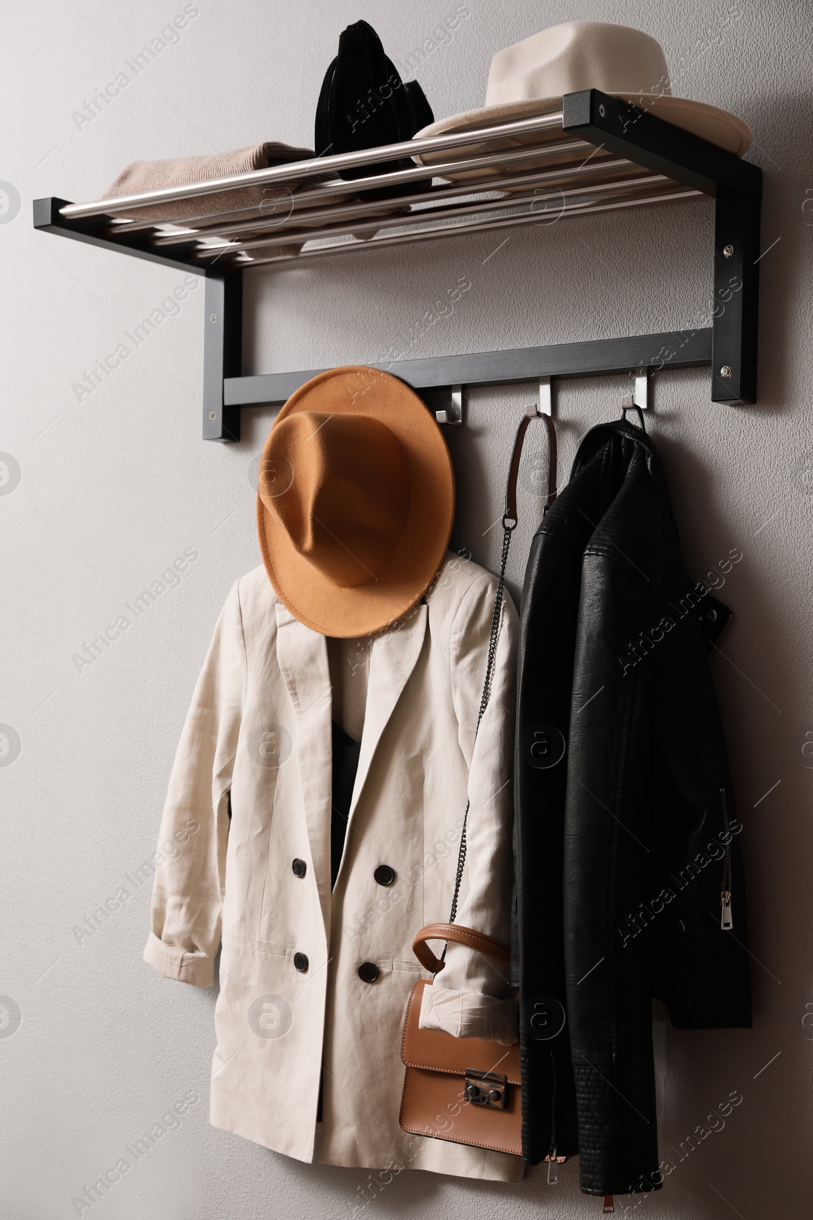 Photo of Hallway interior with stylish furniture, clothes and accessories