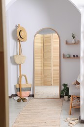 Photo of Hallway interior with stylish furniture and floor mirror