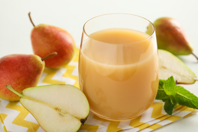 Tasty pear juice and fruits on table, closeup