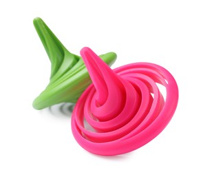 Photo of Green and pink spinning tops isolated on white
