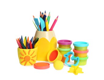 Photo of Set of bright play dough with tools and colorful pencils on white background