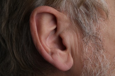 Photo of Closeup view of mature man , focus on ear