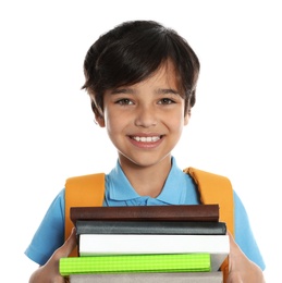 Happy boy in school uniform with stack of books on white background