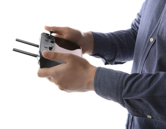 Man holding new modern drone controller on white background, closeup of hands