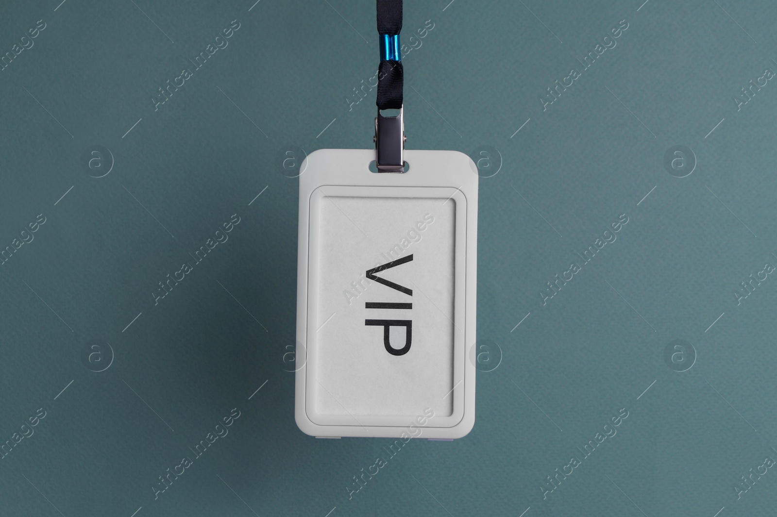 Photo of White plastic vip badge hanging on color background