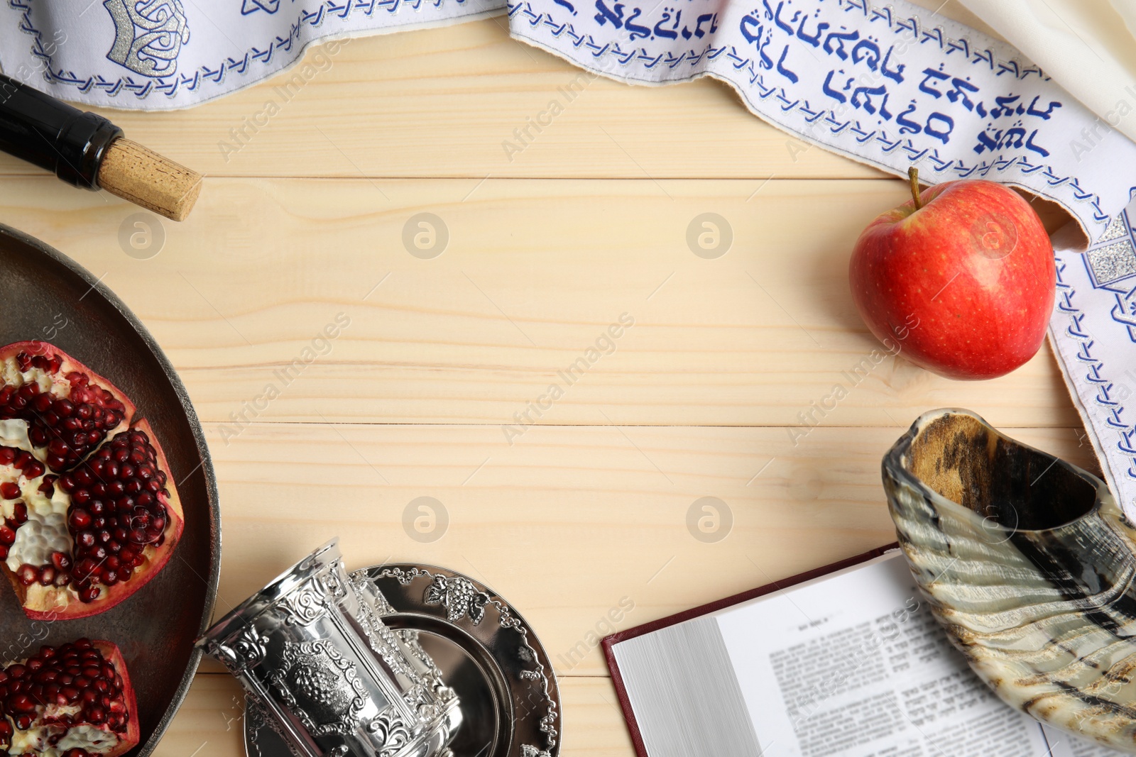 Photo of Frame of Rosh Hashanah holiday attributes on wooden table, flat lay. Space for text