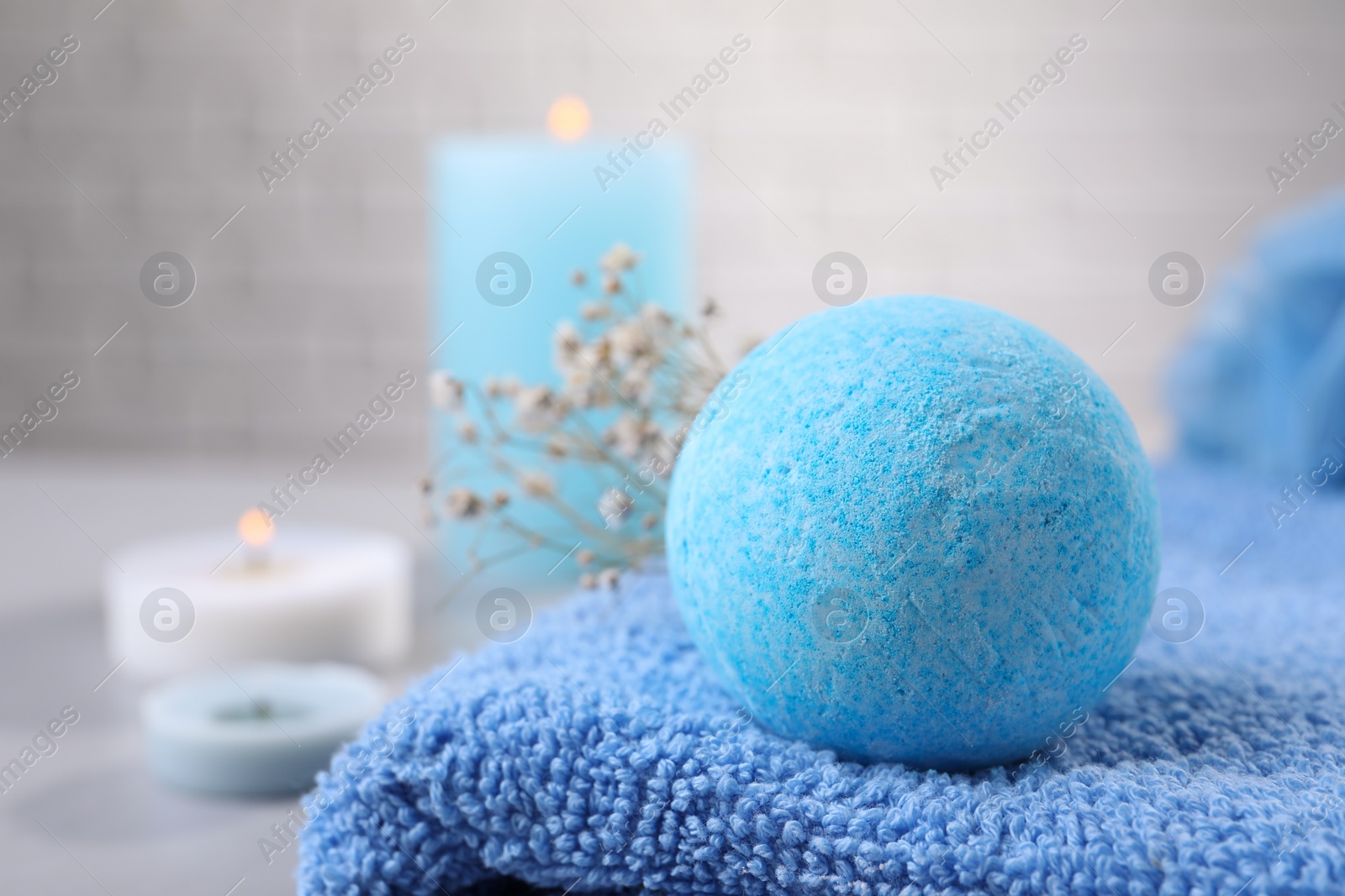 Photo of Beautiful aromatic bath bomb on towel, closeup. Space for text