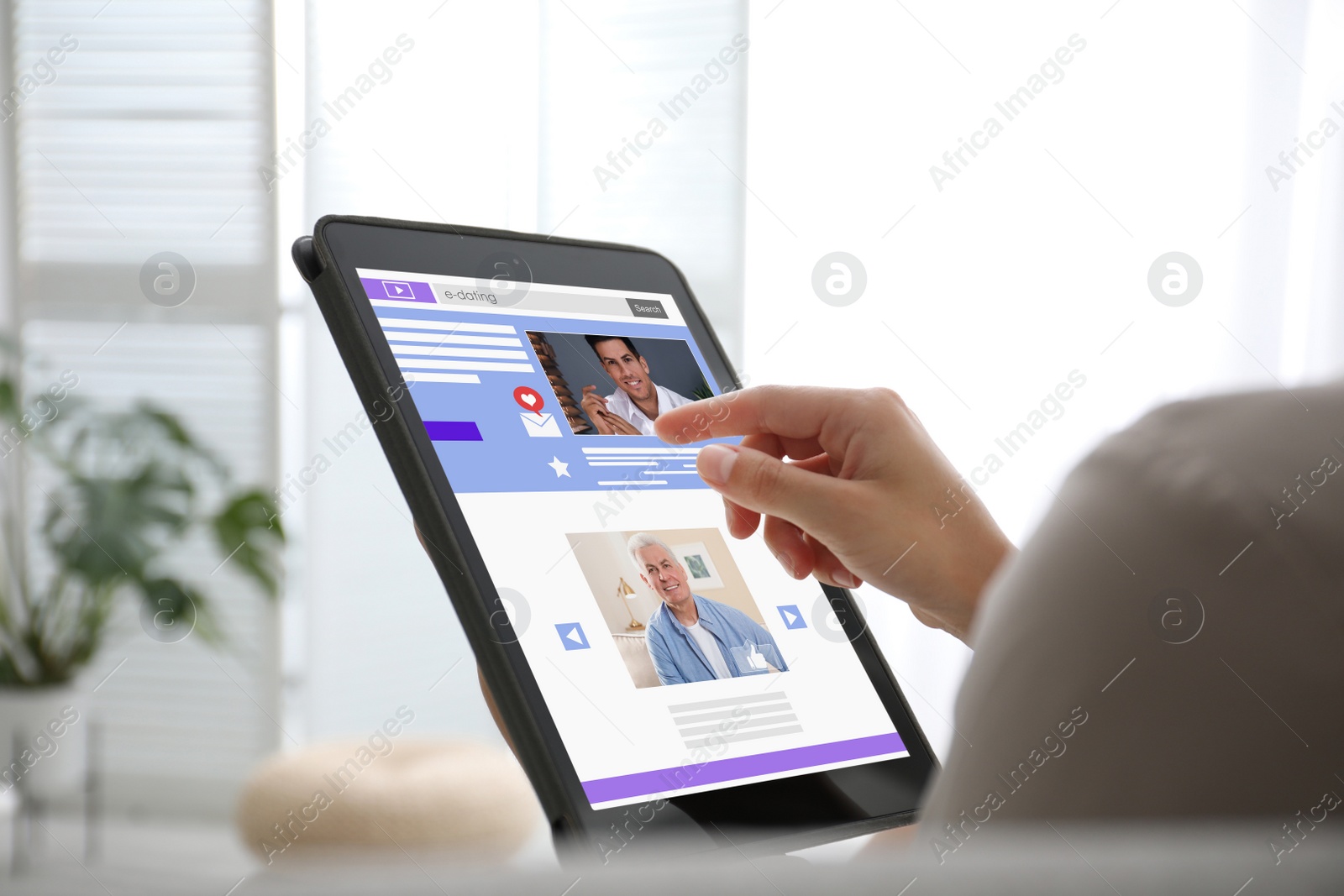 Image of Young woman visiting online dating site via tablet indoors, closeup