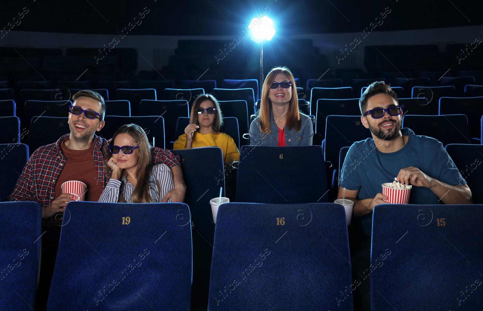 Photo of Young people watching movie in cinema theatre