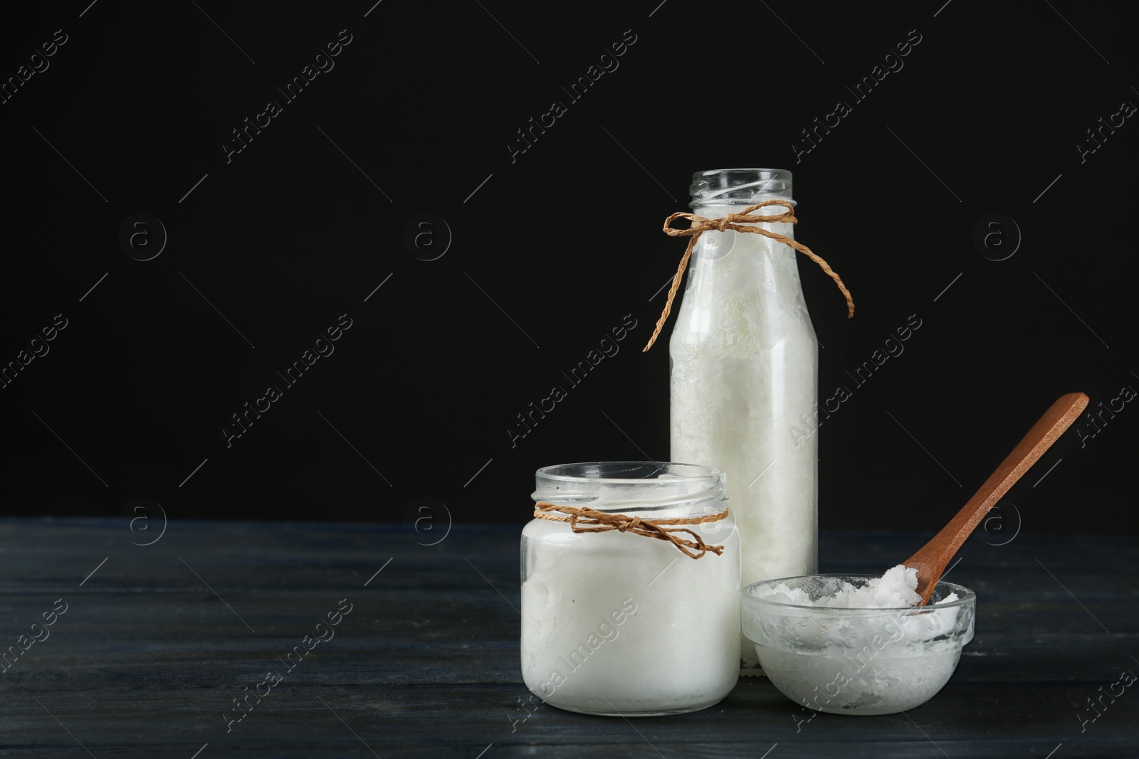 Photo of Fresh coconut oil on dark wooden table, space for text. Cooking ingredient