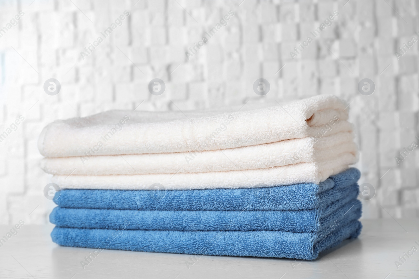 Photo of Stack of soft bath towels on table