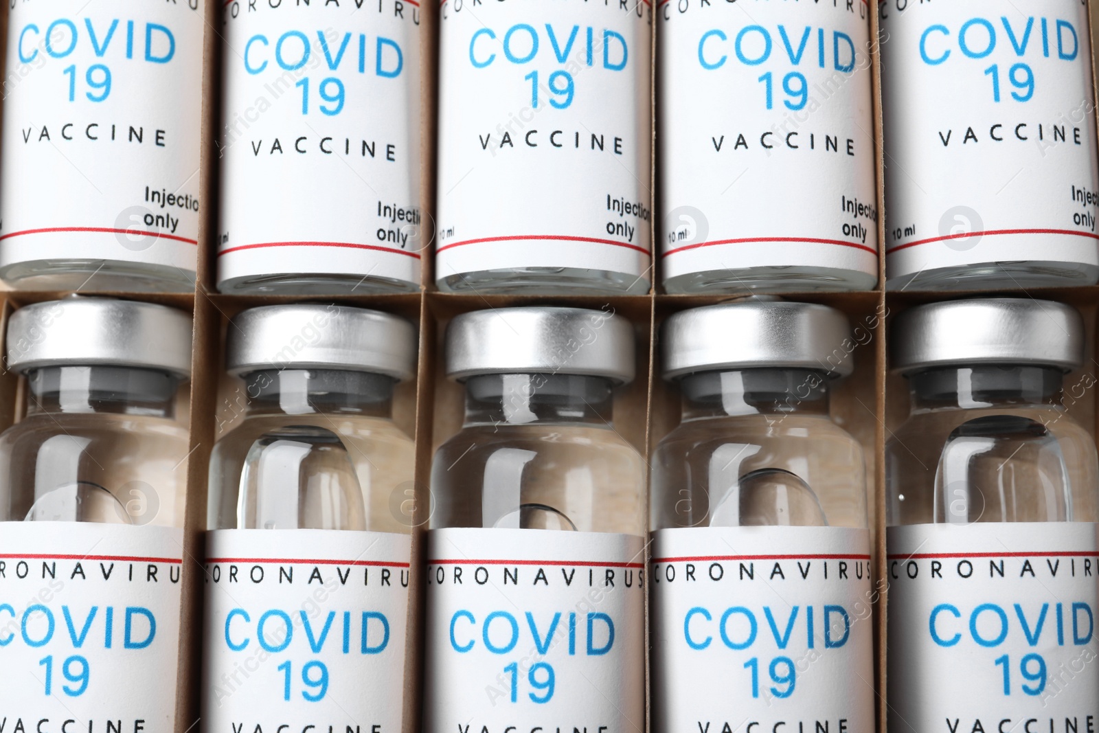 Photo of Glass vials with COVID-19 vaccine in package, top view