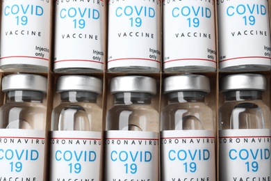 Glass vials with COVID-19 vaccine in package, top view