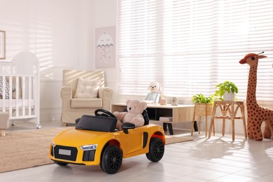 Photo of Yellow car in room at home. Child's toy