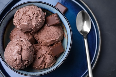 Photo of Yummy chocolate ice cream served on black table, top view