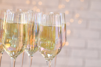 Photo of Glasses of champagne against blurred lights, closeup