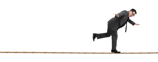 Risks and challenges of owning business. Man balancing on rope against white background, banner design