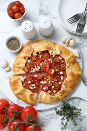 Photo of Flat lay composition of tasty galette with tomato, thyme and cheese (Caprese galette) on white marble table