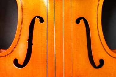 Photo of Beautiful classic violin on black background, closeup view