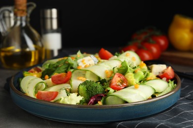Delicious salad with lentils, vegetables and cheese on grey table
