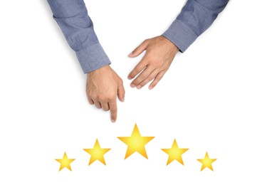 Quality evaluation. Businessman pointing at virtual golden stars on white background, closeup