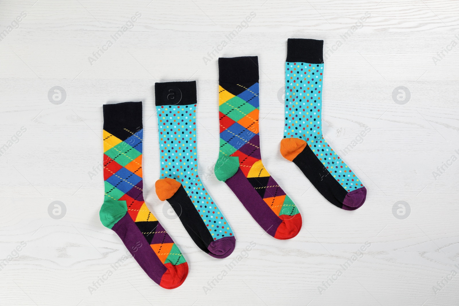 Photo of Flat lay composition with different socks  on light wooden background