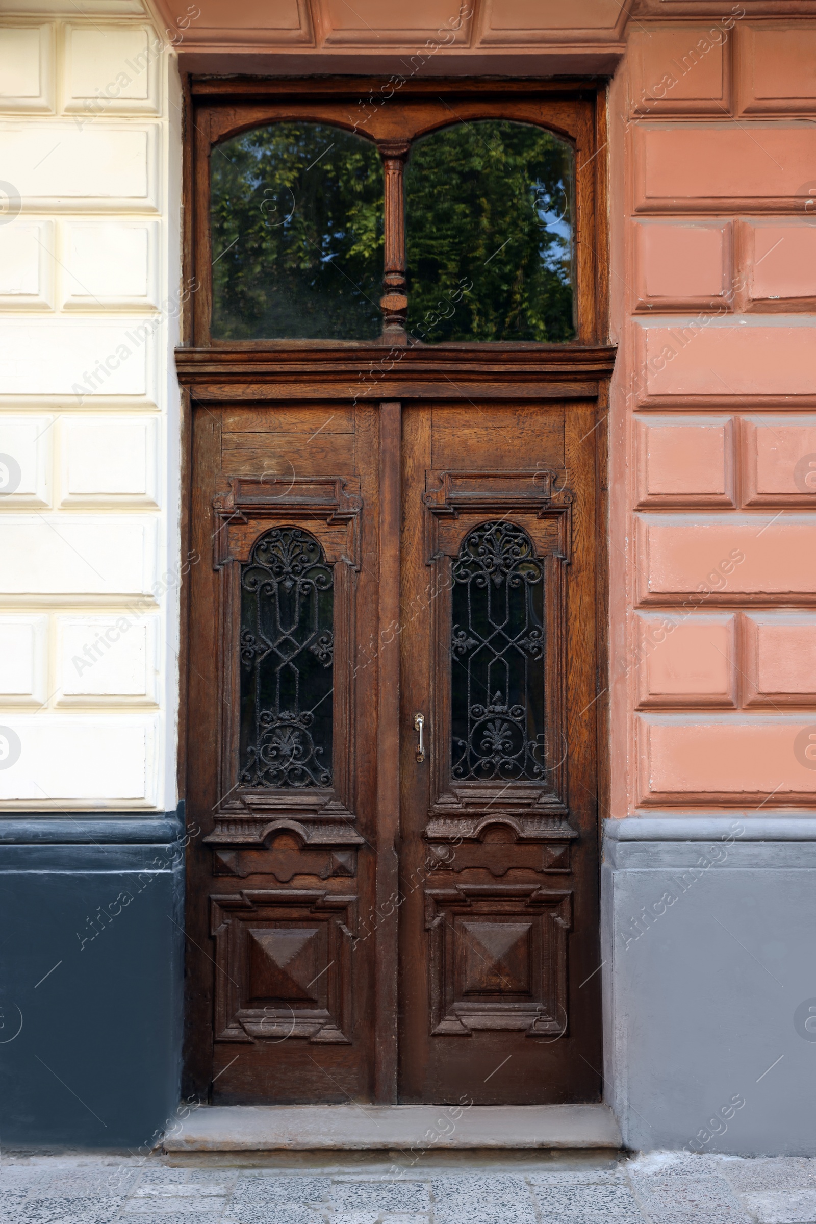 Photo of Entrance of house with beautiful wooden door and transom window