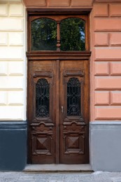 Entrance of house with beautiful wooden door and transom window