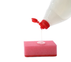 Photo of Pouring cleaning product for dish washing onto sponge on white background